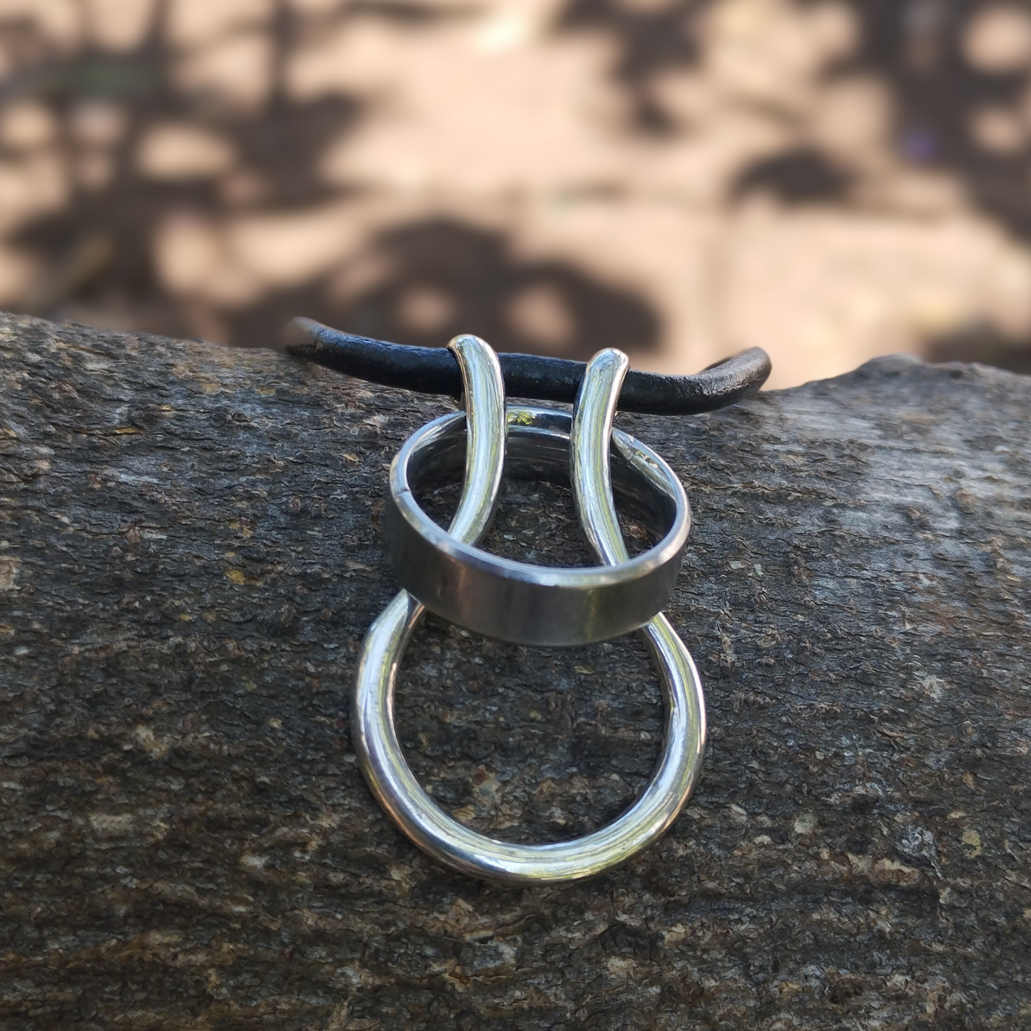 handmade silver ring saver necklace with leather thong for men's wedding rings made in Africa